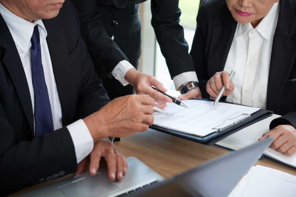 Two people reviewing documents in an office