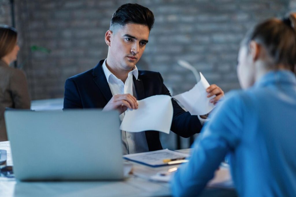 Two people reviewing documents in an office