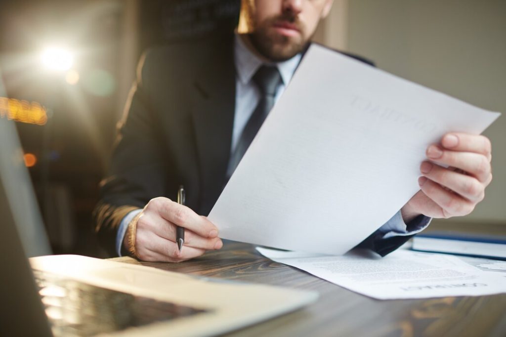 Person in a suit reviewing a document