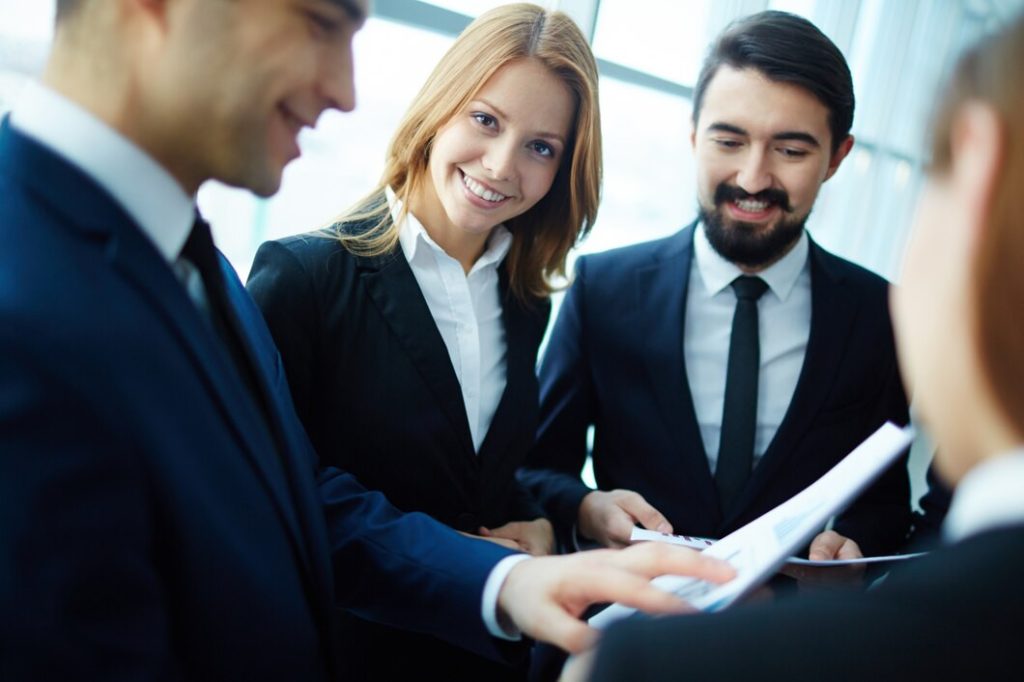 Three business lawyers serving Orange County reviewing documents together.