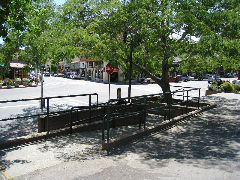 A wheelchair ramp with black metal railings leading down to an underground area near a Business Lawyer in Fairfax.