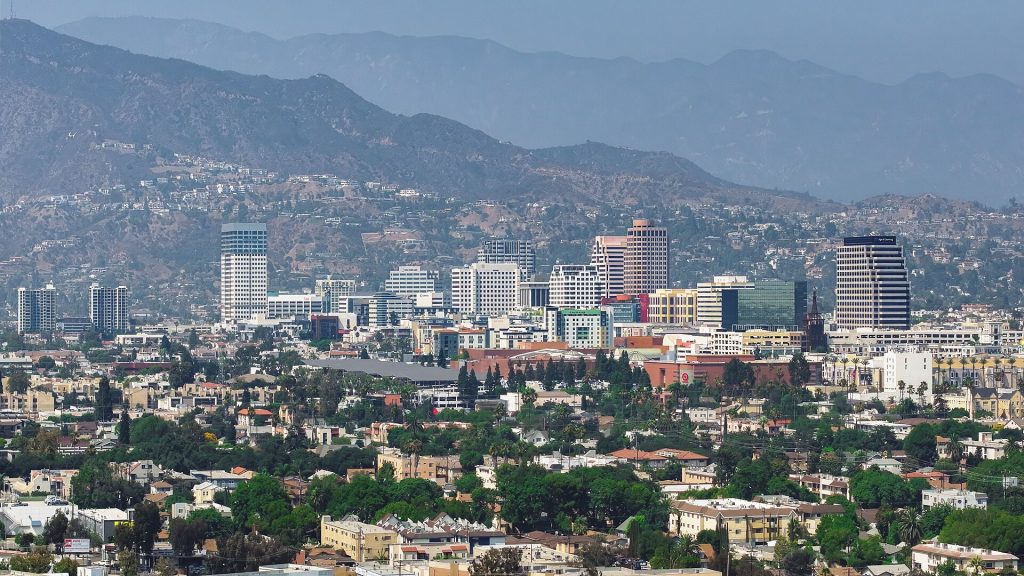 A cityscape of Glendale, California, with a dense cluster of office buildings—home to a business lawyer in Glendale—set against mountains in the background.