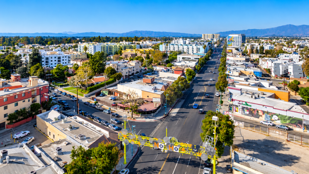 Aerial view of a city street in North Hollywood, where a business lawyer might work, featuring the yellow “NO HO” archway sign spanning the road.