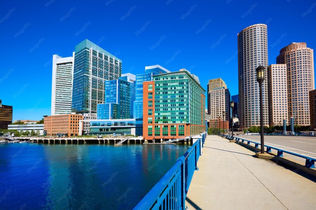 Modern office buildings along the Boston waterfront, viewed from a pedestrian walkway near a business lawyer’s office in Alhambra.