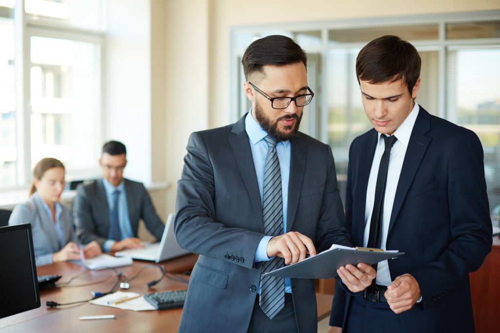 Two businessmen reviewing documents together