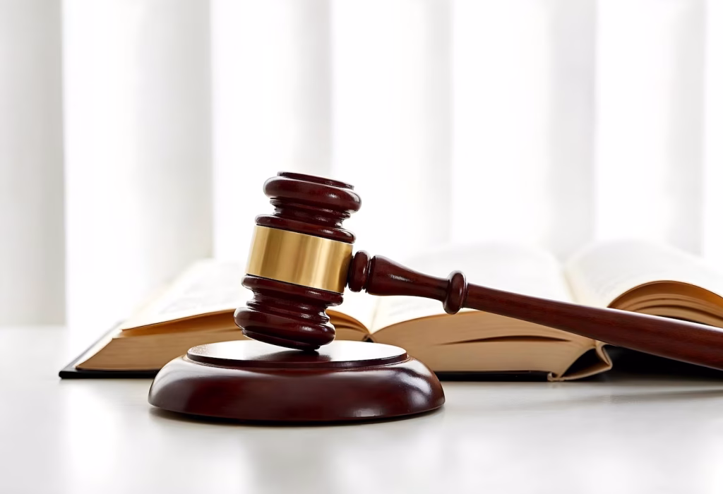 A wooden gavel rests on a sounding block in front of an open law book, reflecting the work of a business lawyer in DTLA.