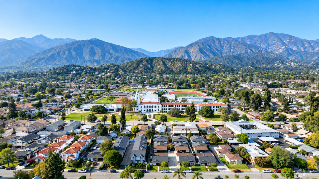 Aerial view of a residential neighborhood and school complex nestled near the mountains, a scenic setting for a business lawyer in Monrovia.
