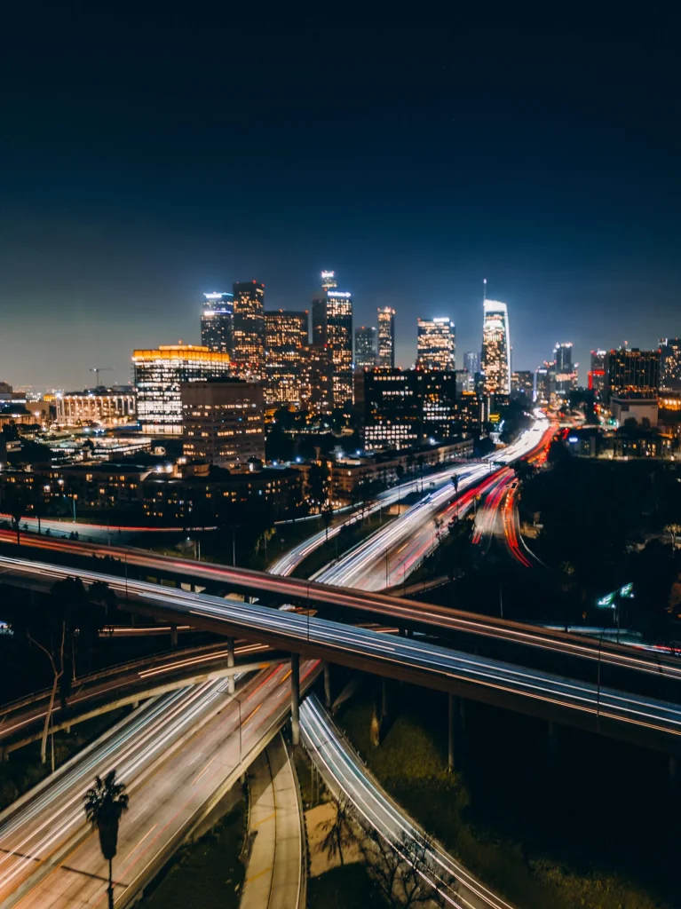 City skyline at night with a lit freeway