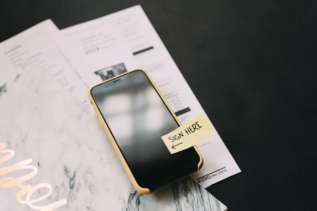 Mobile phone and pen on a desk