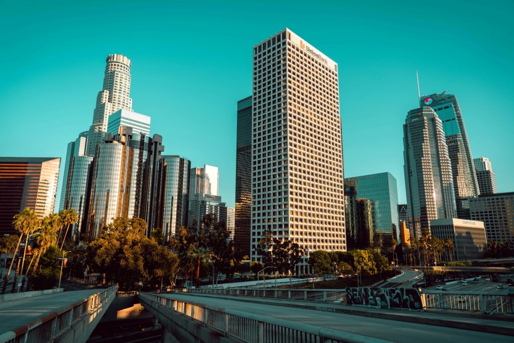 The Los Angeles city skyline, featuring the Union Bank tower above a highway overpass, as seen by a commercial law attorney in Los Angeles.