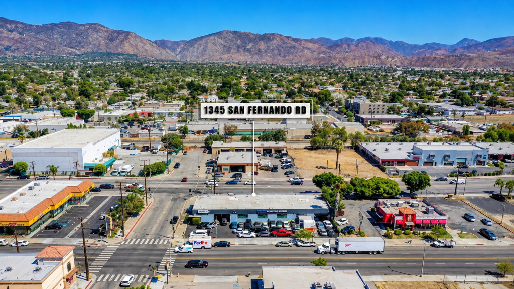 Aerial view of a commercial district and the office of a business lawyer in San Fernando, with mountains in the background.