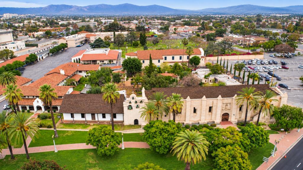 Aerial view of the San Gabriel Mission, with its red-tiled roofs and courtyard, set within the city where a local business lawyer in San Gabriel might practice.