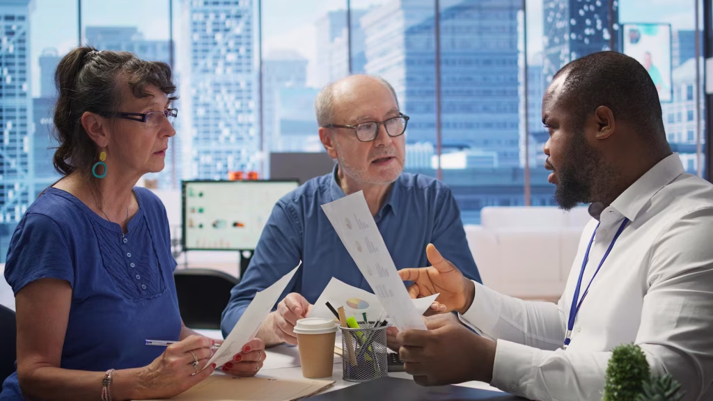 Three people in discussion at a table