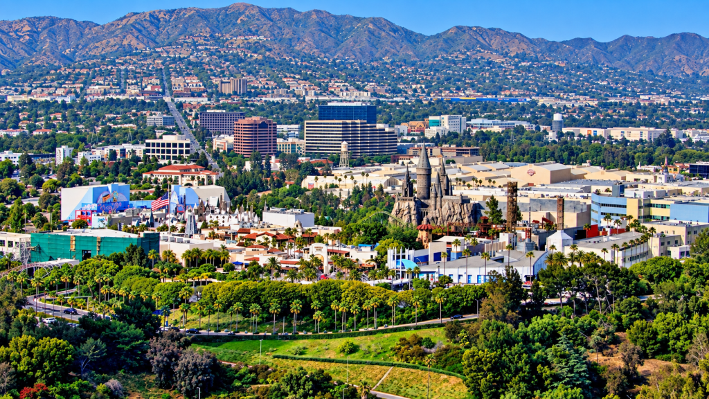 Aerial view of Universal Studios Hollywood, including the Wizarding World of Harry Potter, with urban hillsides where a business lawyer in Studio City might practice.