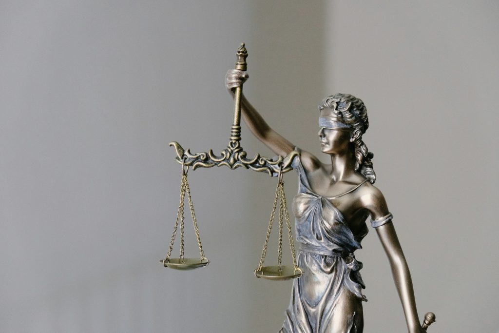 Bronze statue of Lady Justice holding a balanced scale, representing a Business Lawyer in Inglewood.