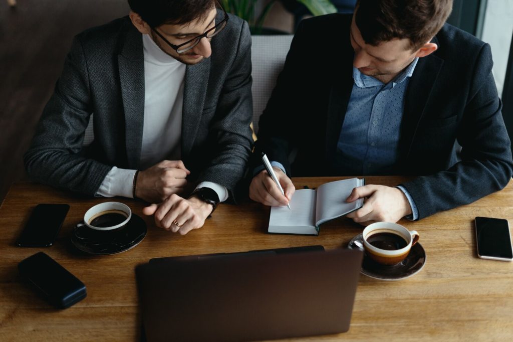 Two people talking over coffee at a table