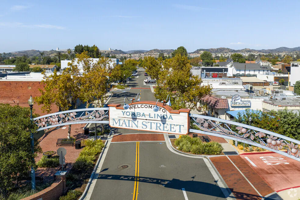 Overhead view of the “Welcome to Yorba Linda Main Street” arch, spanning the road near a business lawyer in Yorba Linda.